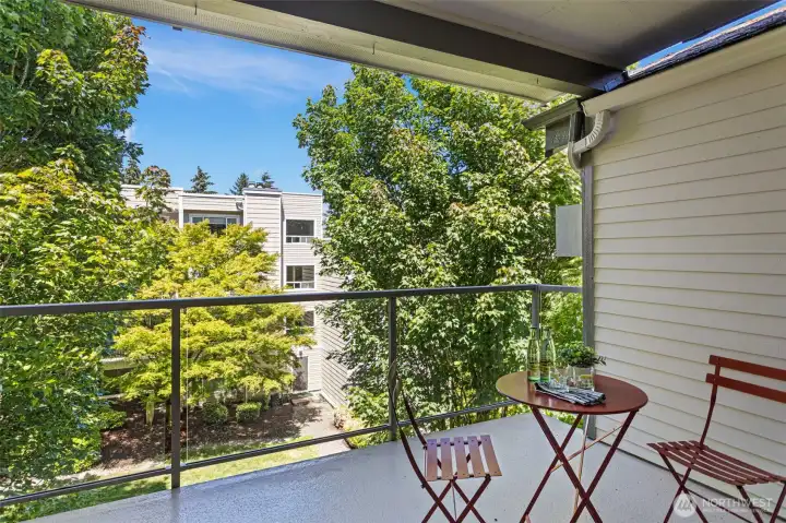 Lush views from the covered deck that overlooks the common grounds and paths. Lush views from the covered deck that overlooks the common grounds and paths.