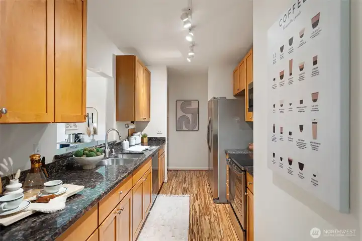 Kitchen with slab granite counters and cherry cabinets. Around the corner is a bonus laundry room! Kitchen with slab granite counters and cherry cabinets. Around the corner is a bonus laundry room!