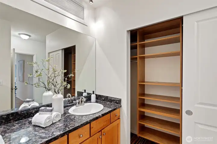 Primary bedroom closet with organizers conveniently located next to where you get ready. Primary bedroom closet with organizers conveniently located next to where you get ready.