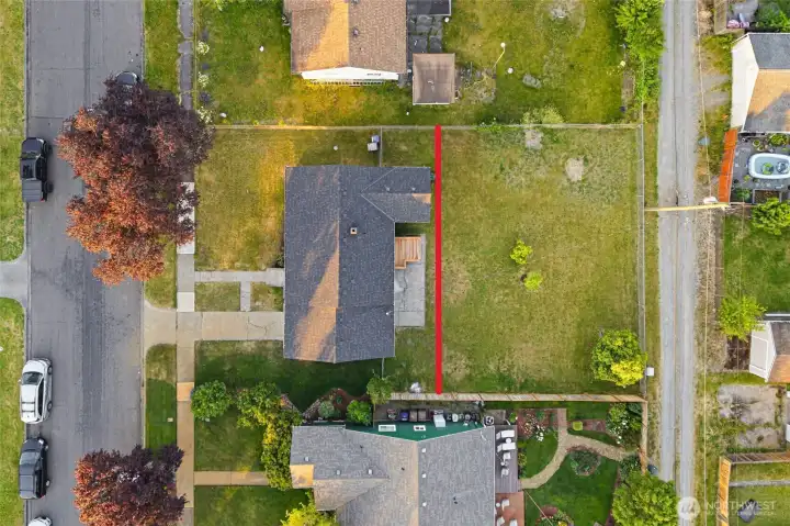Backyard to be subdivided prior to closing. The red line shown in the photo represents the approximate future fence line. Photo is for reference only and does not represent the final lot configuration.