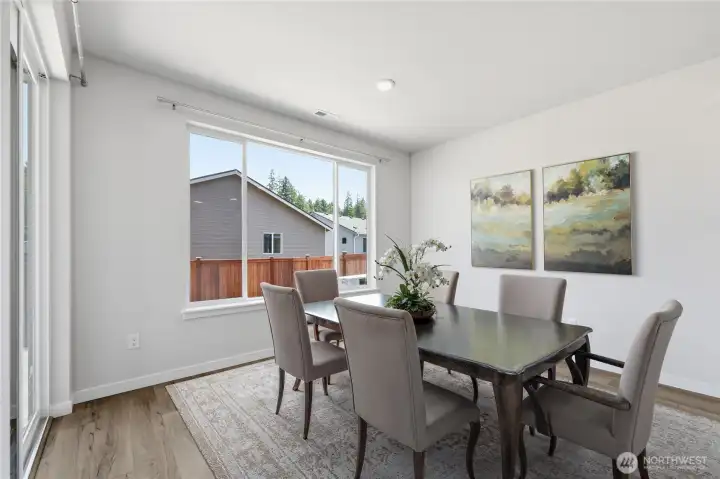 Virtually staged dining area. Virtually staged dining area.
