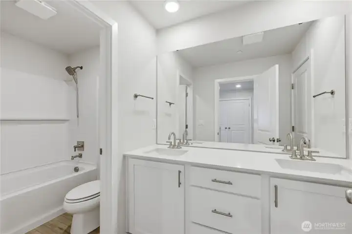 A full bathroom with 2 sinks and quartz countertop. A full bathroom with 2 sinks and quartz countertop.