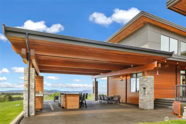 Outdoor kitchen with BBQ, fridges, & fireplaces