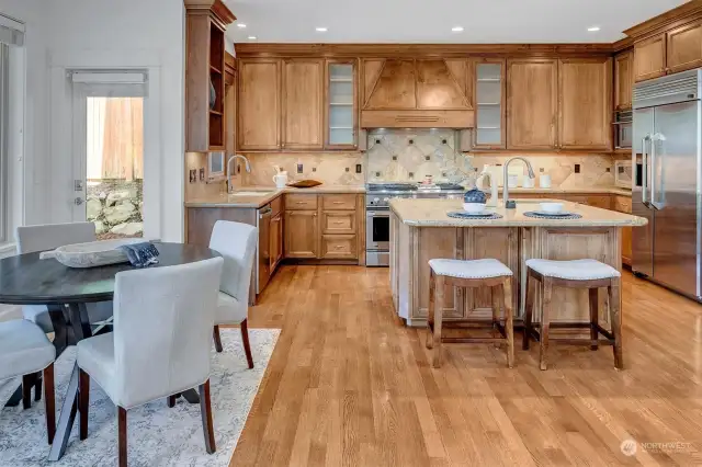 The Chef's kitchen is large, open and ideal for entertaining. Real hardwoods, custom cabs and granite counter/island w/prep sink.  Abundant storage includes a walk in pantry and Butlers pantry too!