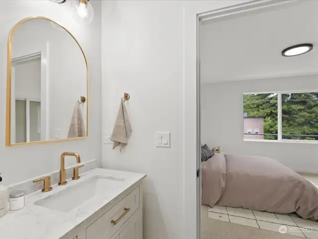 Primary bathroom - STUNNING custom shower with double vanity & custom gold features. [Photo is virtually staged.]