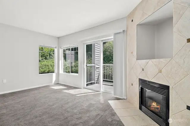 Living room with gas fireplace and slider to balcony