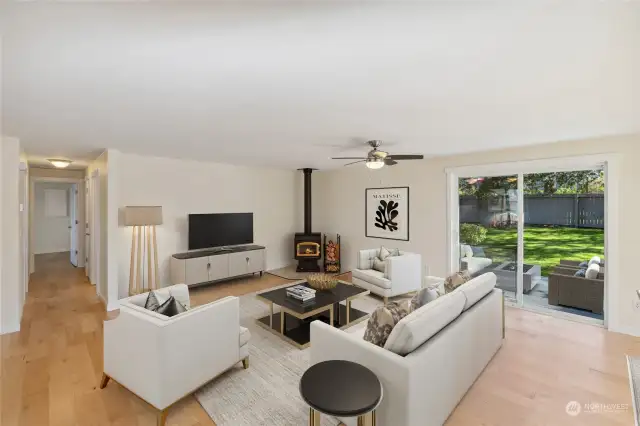 Virtually staged living room features door to back yard and cozy wood burning fireplace.  New engineered wood flooring throughout!