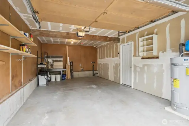 Attached 1-car garage with utility space along back wall