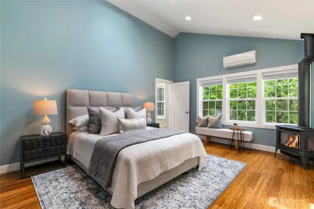 Primary bedroom with mini-split heat/AC, plus freestanding fireplace.