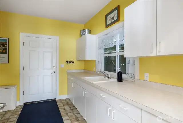 Very nice (room for everything in here) Laundry room.  Door to the 2 garage.  The garage is finished with sheetrock and painted