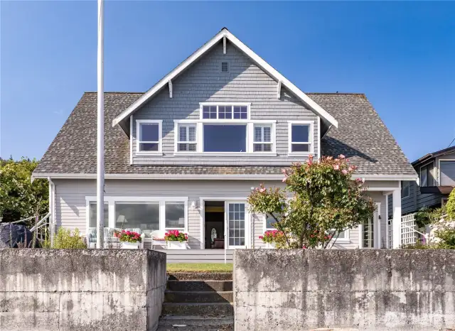 Bulkhead keeps your yard a yard and the Beach on the Beach.  The upstairs center window is the open Family room