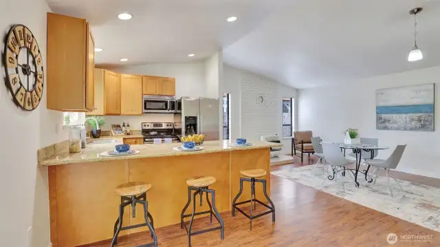 Dining room offers plenty of room for a large dining table or enjoy a quick bite with bar seating right in the kitchen.