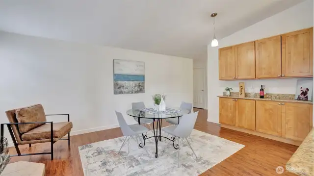 This dining space just off the kitchen features a breakfast bar with additional cabinet space for extra storage and the perfect setup for serving guests.