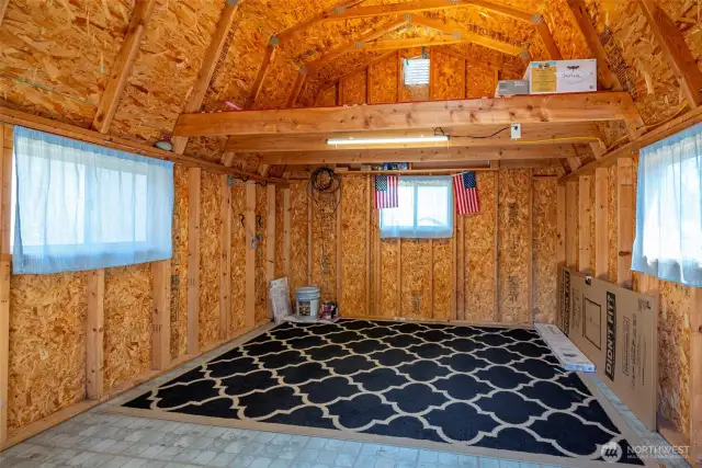 Bright and light interior of the storage shed with 3 windows, a skylight and loft area.