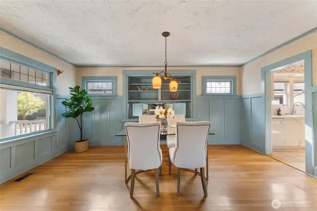 Large dining room features built ins and original leaded glass windows,