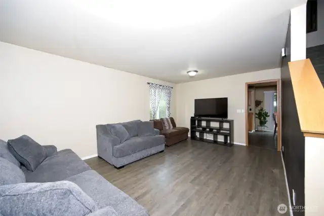 Large living room with laminate flooring.
