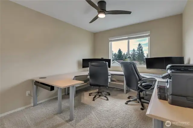 Bedroom 3 being used as an office with custom build desks.