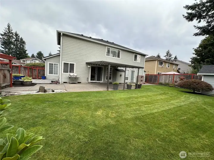 Backyard includes a basalt rock water fountain, large concrete patio, awning, side deck, an 8'x 14' outbuilding that matches the house, and 2 sheds on the east side of the house to keep your yard equipment and tools.