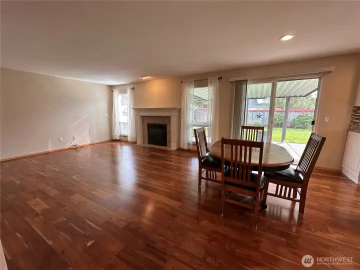 View of the family room with gas fireplace and eat-in kitchen area (wide angle lens view)
