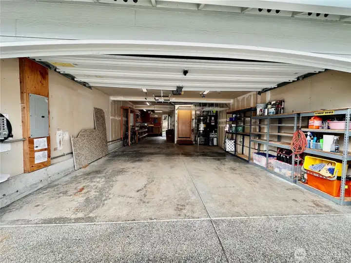Tandem 3 car garage.  The back bay is currently configured as a workshop with a back door that goes out to the backyard.