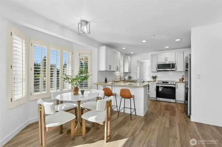 Light-filled kitchen & eating area with quartz counter tops & stainless steel appliances!