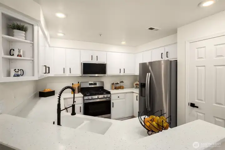 Refreshed kitchen with painted cabinets, new hardware and faucet, new stainless steel appliances. Lots of countertop space and a great pantry for storage