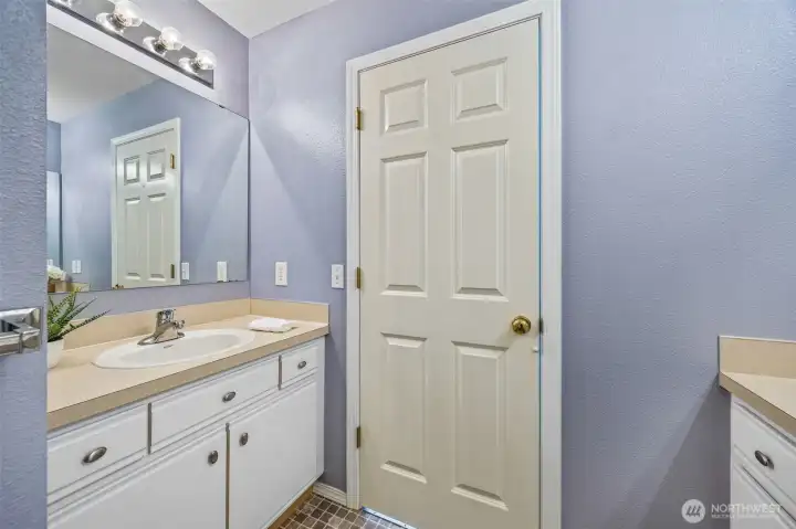 Ample storage and a clean coastal palette make this bathroom both practical and refined.