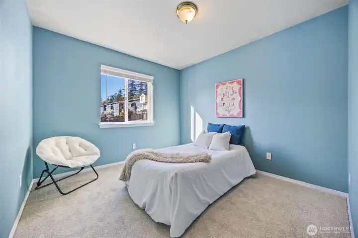 Large secondary bedroom with generous closet space, custom blinds, and fresh paint—ready for guests or a creative workspace.