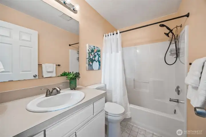 Spacious upstairs bath with full tub/shower combo and modern finishes completes the upper level.