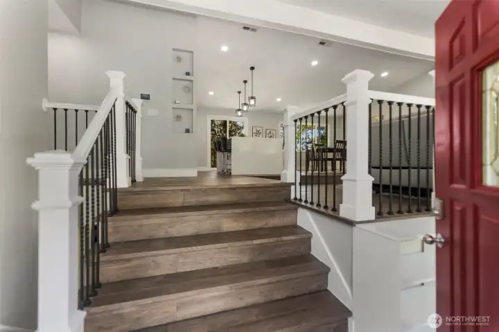 Welcome home! A spacious entryway greets you with the living room to the right and the dining room next to it. The open staircase railing is a custom feature allows for abundant light to flow throughout.