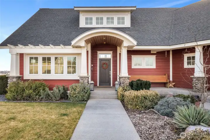 The arched front entry welcomes you and your guests into this beautiful, custom-built, one-of-a-kind Craftsman home built by Bruce Preston.