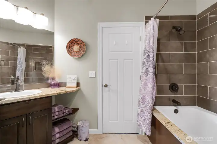 A spa-like bath connected to the 2nd primary bedroom and hallway is designed for slow mornings and peaceful evenings.