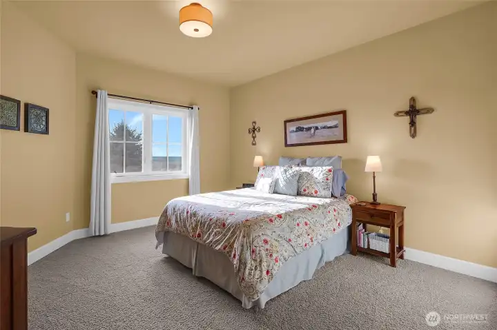 This second primary suite offers main-floor convenience and a breathtaking lake backdrop—perfect for guests or multi-generational living.