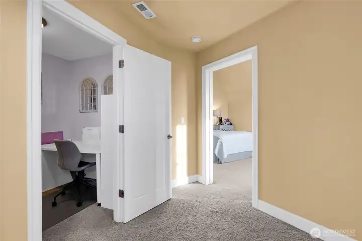 As you move leisurely from the first upper level bedroom to the other side of the staircase, you'll find a creative space for a writing or sewing room to the left, and the 4th bedroom, which faces the back yard, vineyard, and gives you a view of the lake and valley!