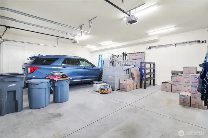The home has a well-built, insulated two-car garage with storage, two hot water tanks, water softener, and space for shelving as well!