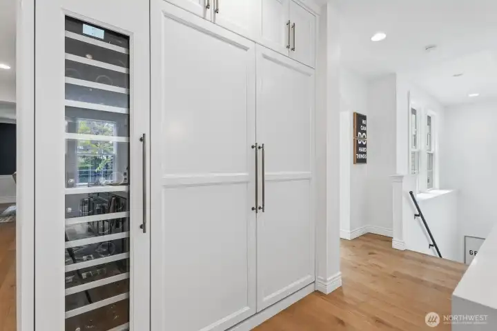 60-bottle wine refrigerator keeps all your favorite bottles at the perfect temp, while the double fridge/freezer is discreetly blended in with cabinet faces.