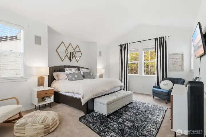 The upper level plays host to five bedrooms, including this stately primary retreat.