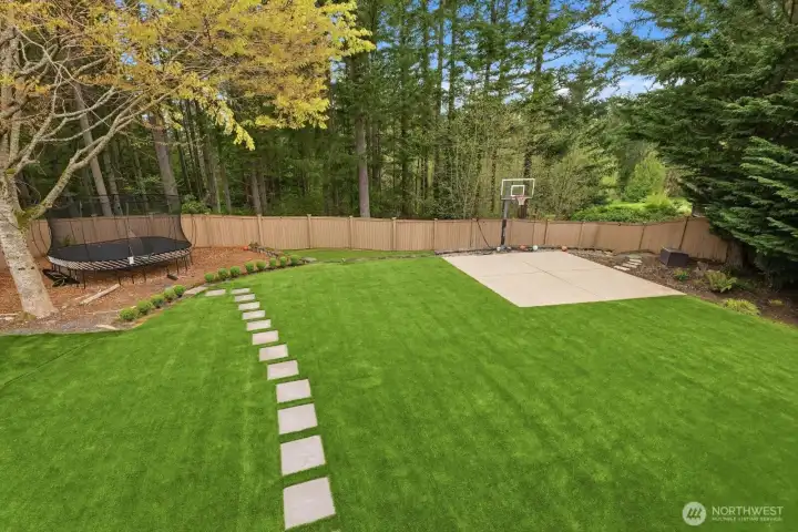 The huge, level and fully fenced backyard comes equipped with a fully synthetic turf yard for year-round enjoyment, a trampolene area, and a basketball court.