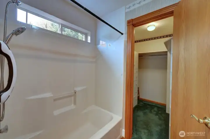 large primary bathroom with walk and walk in closet