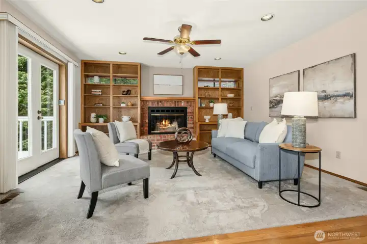 Builtins with wood burning fireplace in the family room.