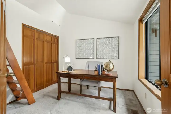 Office/den right off the entry on the main floor with stairs leading to a loft area.