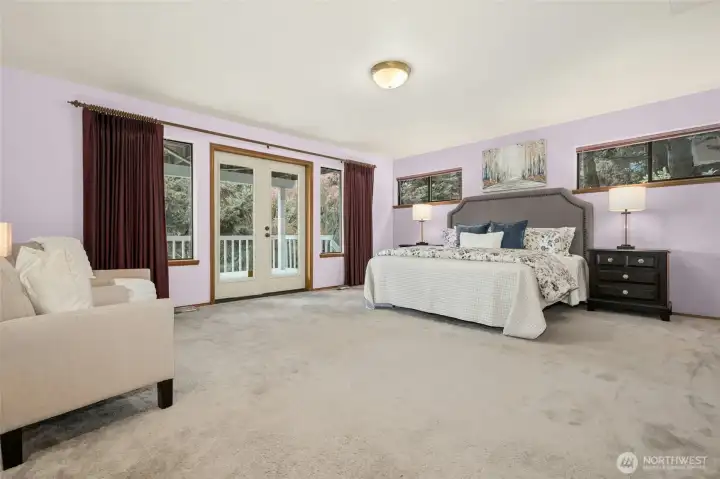 Primary bedroom stays cool in the summer with private access to lower deck.