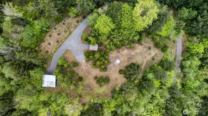 An aerial view showcases the layout as you crest the access road, with fresh gravel thoughtfully placed to provide easy access and maximize the use of the plateau.
