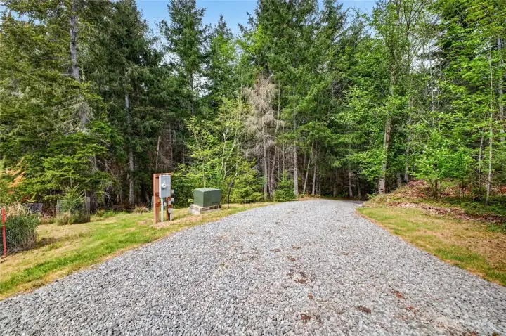 As you crest the access road you see the second transformer, the electrical meter and the stub out for waterline that has been brought up to the site. The well is located in the lower portion of the property.
