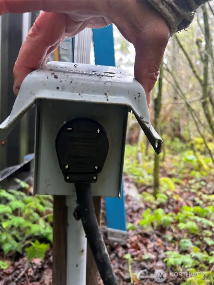 RV power hook up is conveniently located along side of the storage containers.