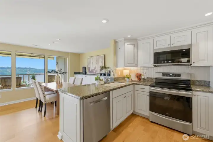Updated kitchen featuring a newer dishwasher (2023), range (2022), microwave (2025), kitchen faucet (2020), and under-cabinet lighting Updated kitchen featuring a newer dishwasher (2023), range (2022), microwave (2025), kitchen faucet (2020), and under-cabinet lighting
