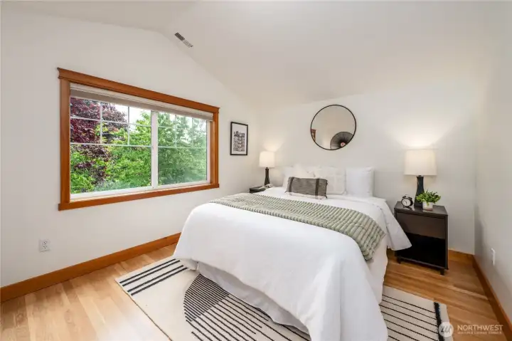 Primary bedroom with vaulted ceilings and yes, hardwood floors!