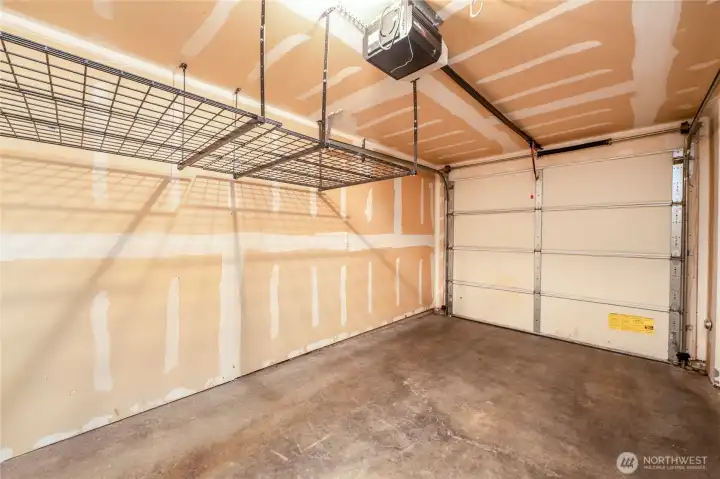 Attached garage with storage racks.