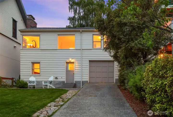 Moderne-influenced Cape Cod tucked along a quiet, tree-lined Bryant street.