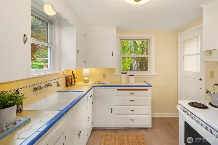 Bright, functional kitchen with direct access to outdoor living and dining.